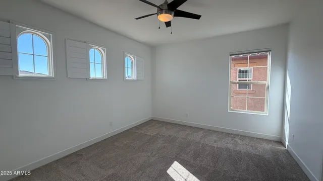 a view of workspace with window and ceiling fan