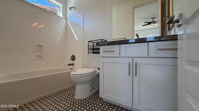 a bathroom with a sink a toilet and a shower