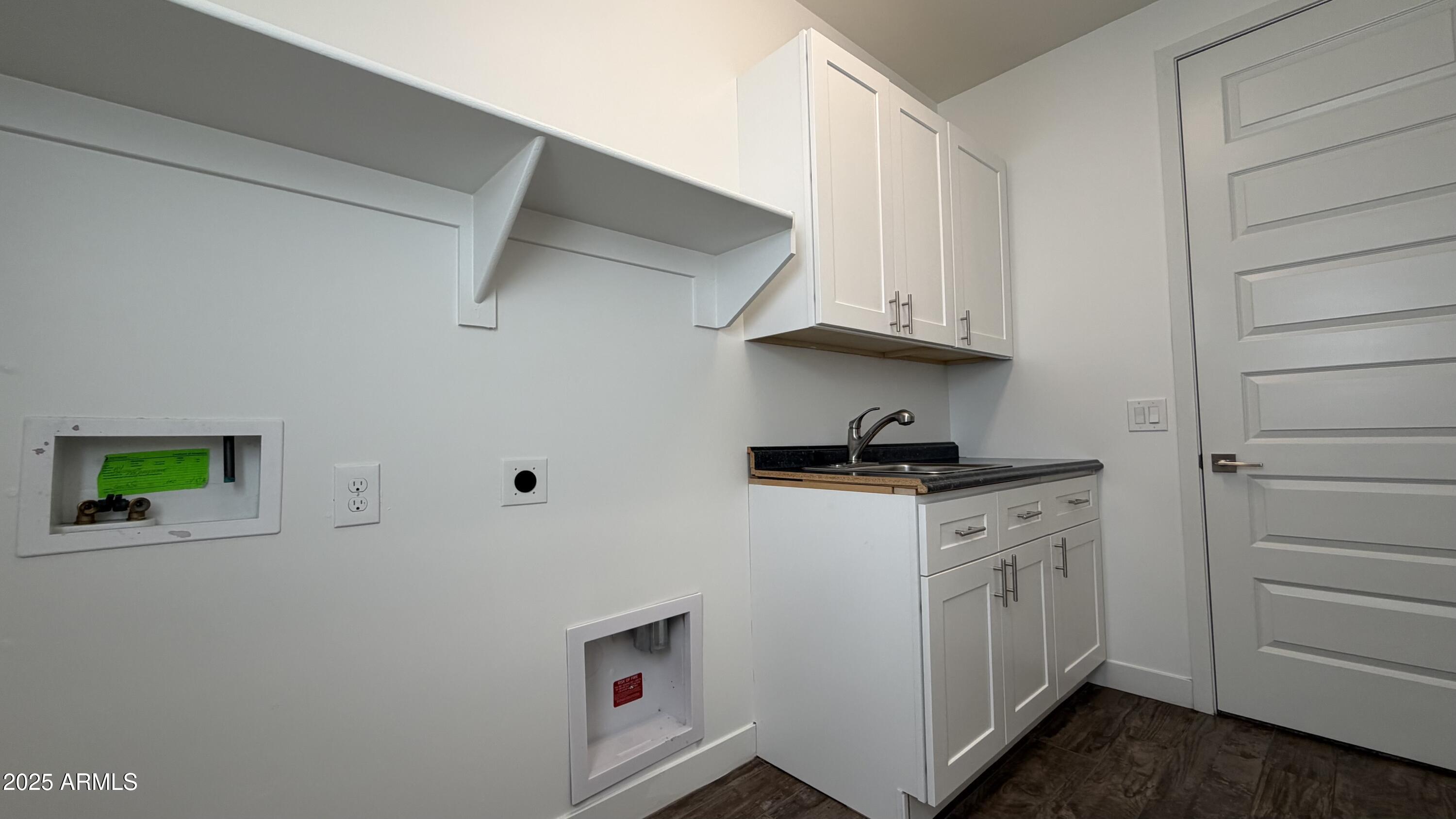 4536 East Walter Way Phoenix, AZ 85050 - Photo 32 of 50 a kitchen with white cabinets and a stove