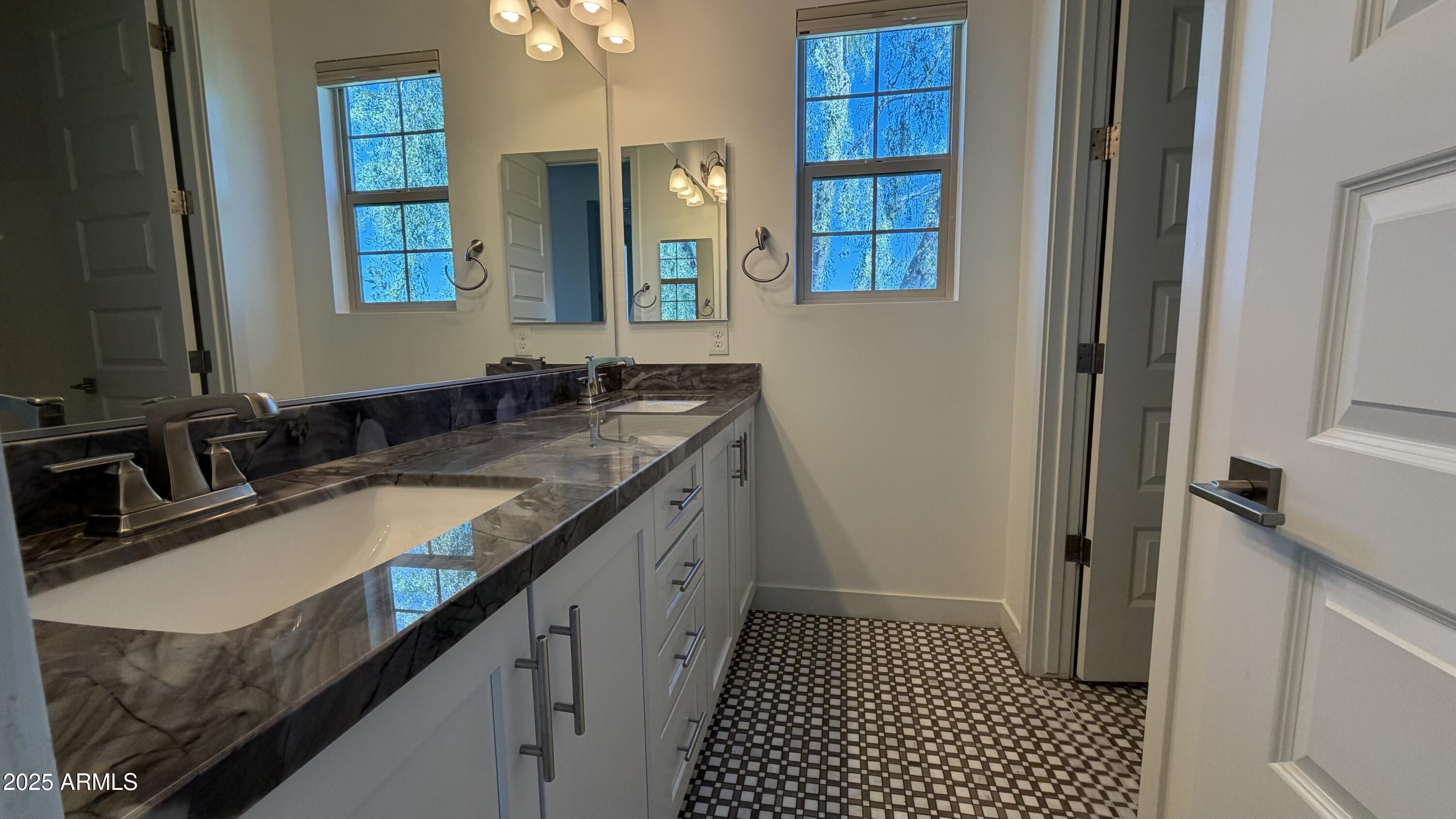 4536 East Walter Way Phoenix, AZ 85050 - Photo 35 of 50 a bathroom with a granite countertop sink and a mirror