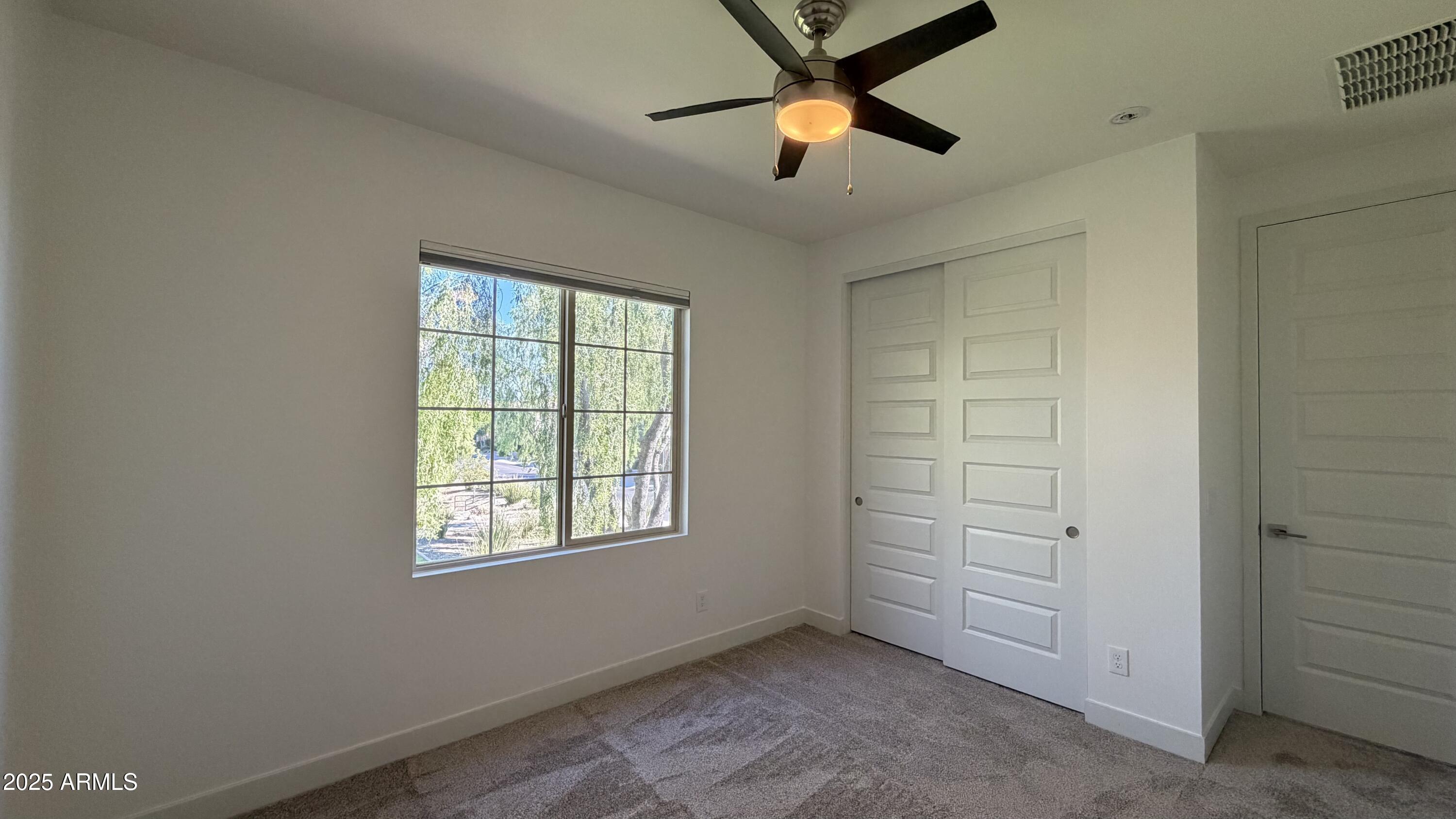 4536 East Walter Way Phoenix, AZ 85050 - Photo 38 of 50 an empty room with closet and chandelier fan