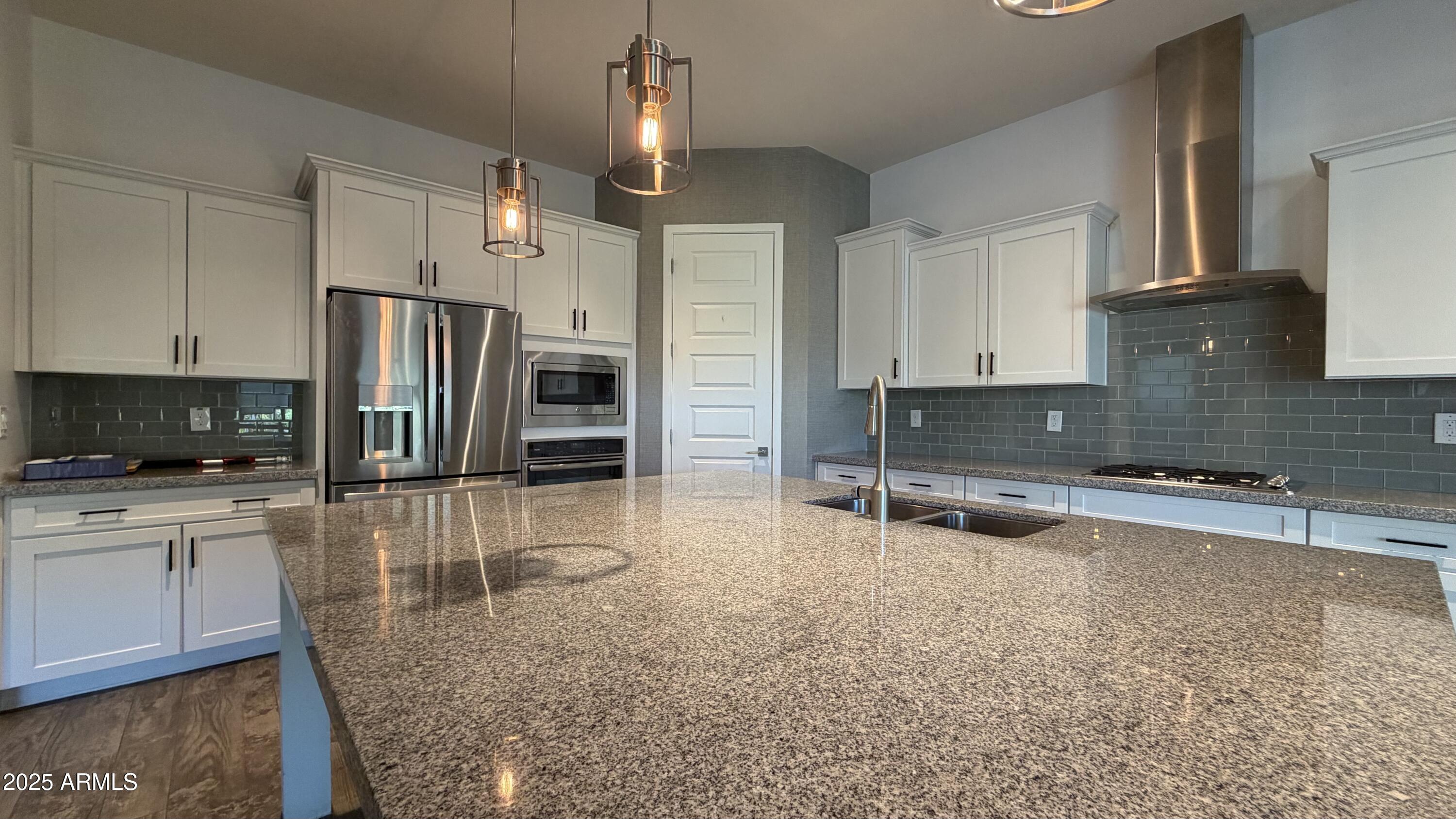 4536 East Walter Way Phoenix, AZ 85050 - Photo 8 of 50 a kitchen with stainless steel appliances granite countertop a sink refrigerator and cabinets