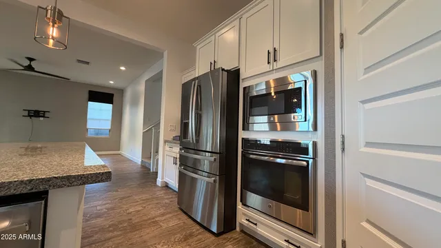 a kitchen with granite countertop a refrigerator and a stove