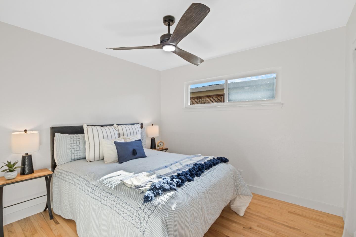 4770 Opal Street Capitola, CA 95010 - Photo 11 of 48 a bedroom with a bed and a ceiling fan