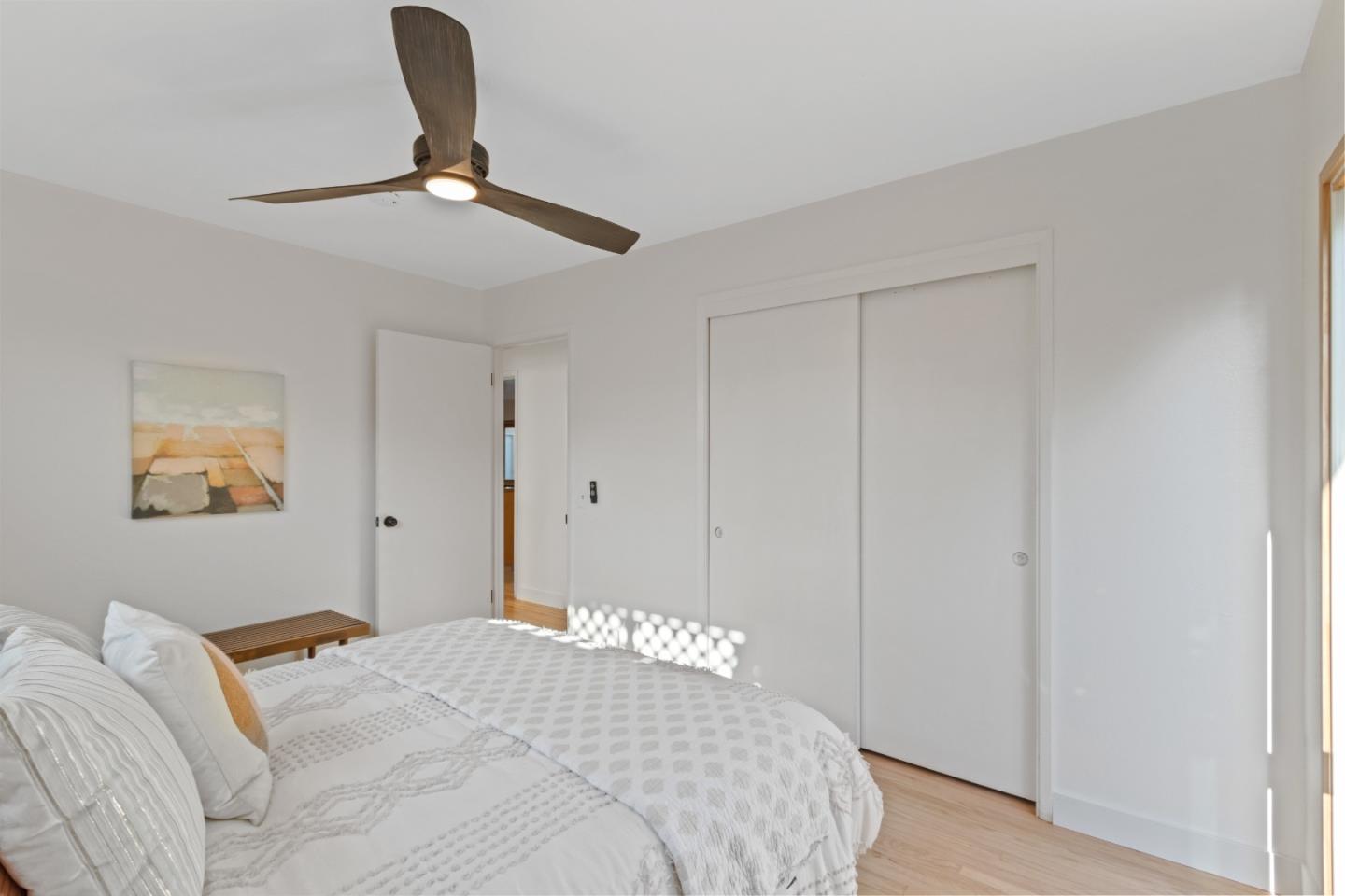 4770 Opal Street Capitola, CA 95010 - Photo 20 of 48 a bedroom with a bed and a chandelier