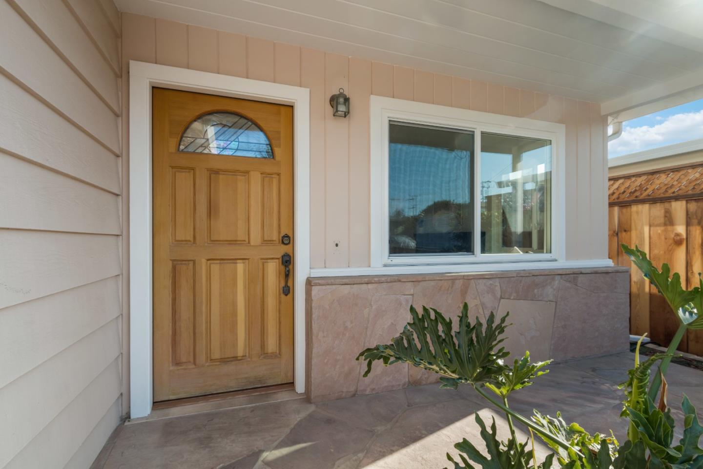 4770 Opal Street Capitola, CA 95010 - Photo 37 of 48 a front view of a house with a potted plant and a window
