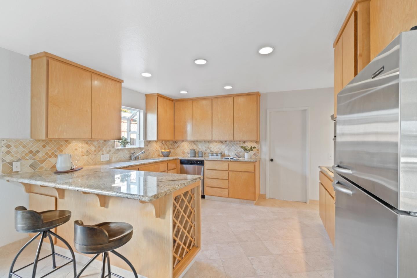 4770 Opal Street Capitola, CA 95010 - Photo 9 of 48 a kitchen with a sink refrigerator and cabinets