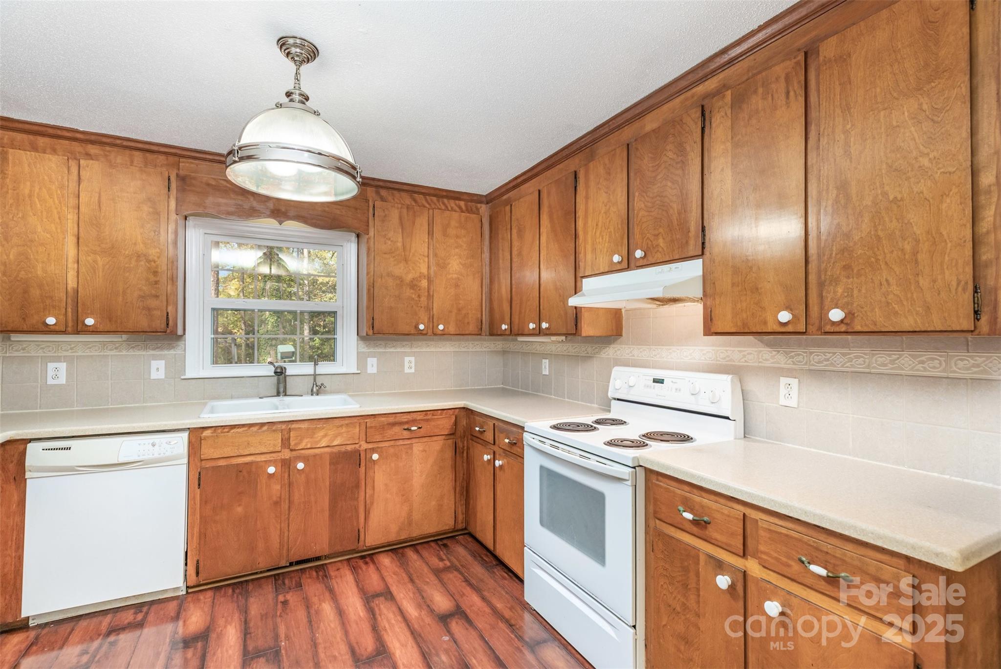211 Ridgewood Drive Monroe, NC 28112 - Photo 11 of 31 a kitchen with cabinets a sink and appliances