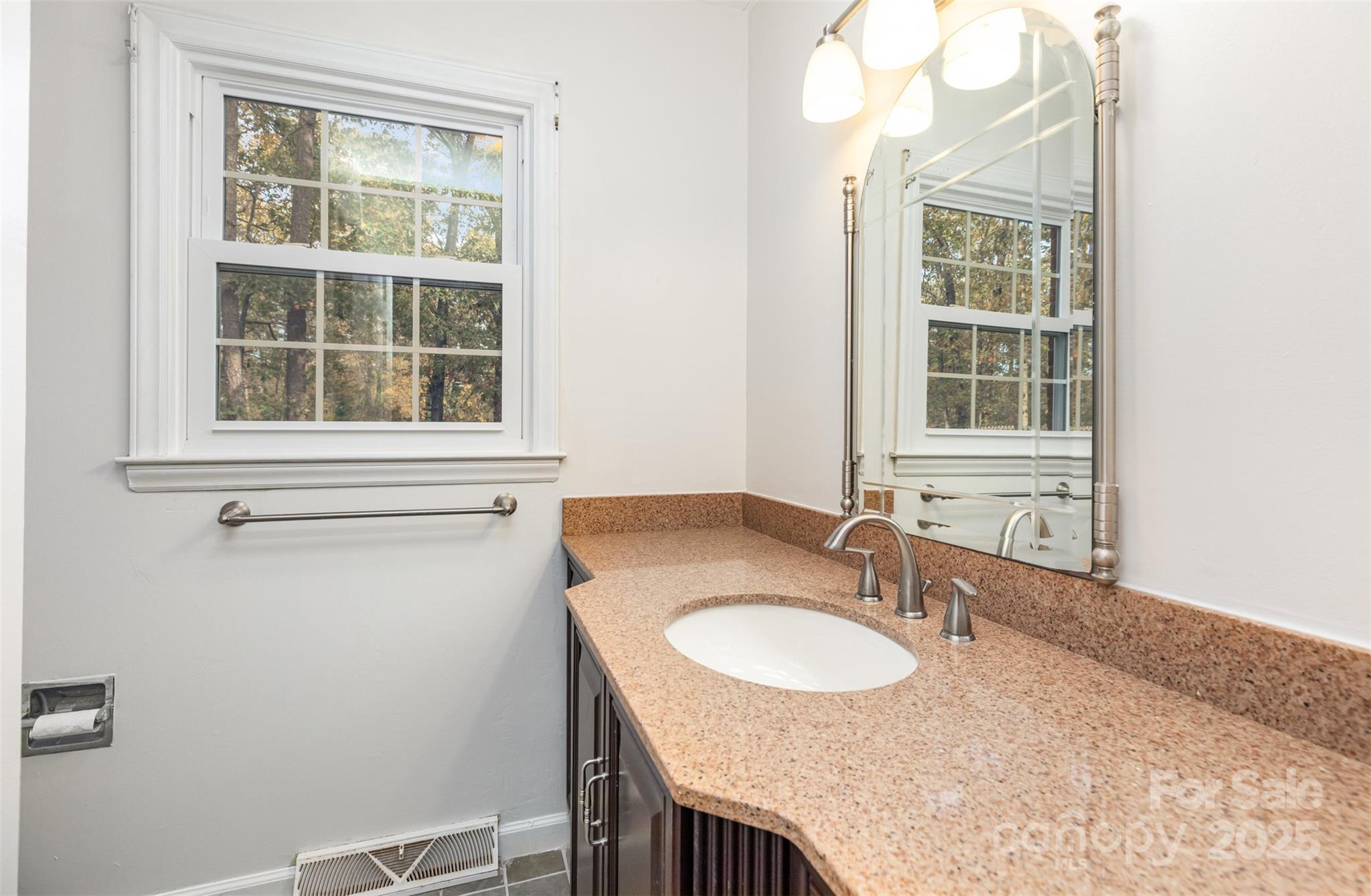 211 Ridgewood Drive Monroe, NC 28112 - Photo 22 of 31 a bathroom with a granite countertop sink a mirror and a window