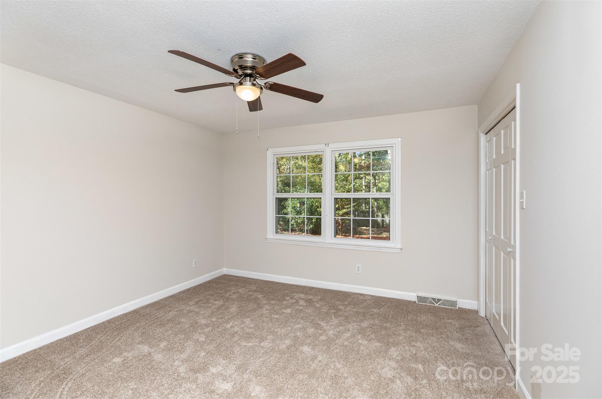 211 Ridgewood Drive Monroe, NC 28112 - Photo 25 of 31 a view of a livingroom with a ceiling fan & windows
