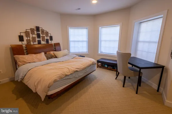 a bed room with a bed and a chair