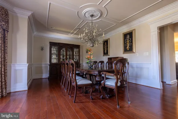 a view of a dining room with furniture wooden floor and chandelier