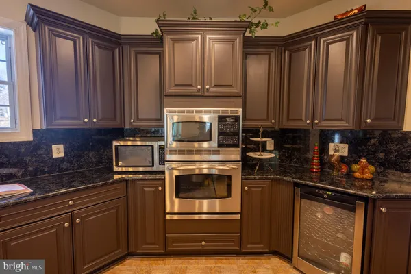 a kitchen with granite countertop a stove and cabinets