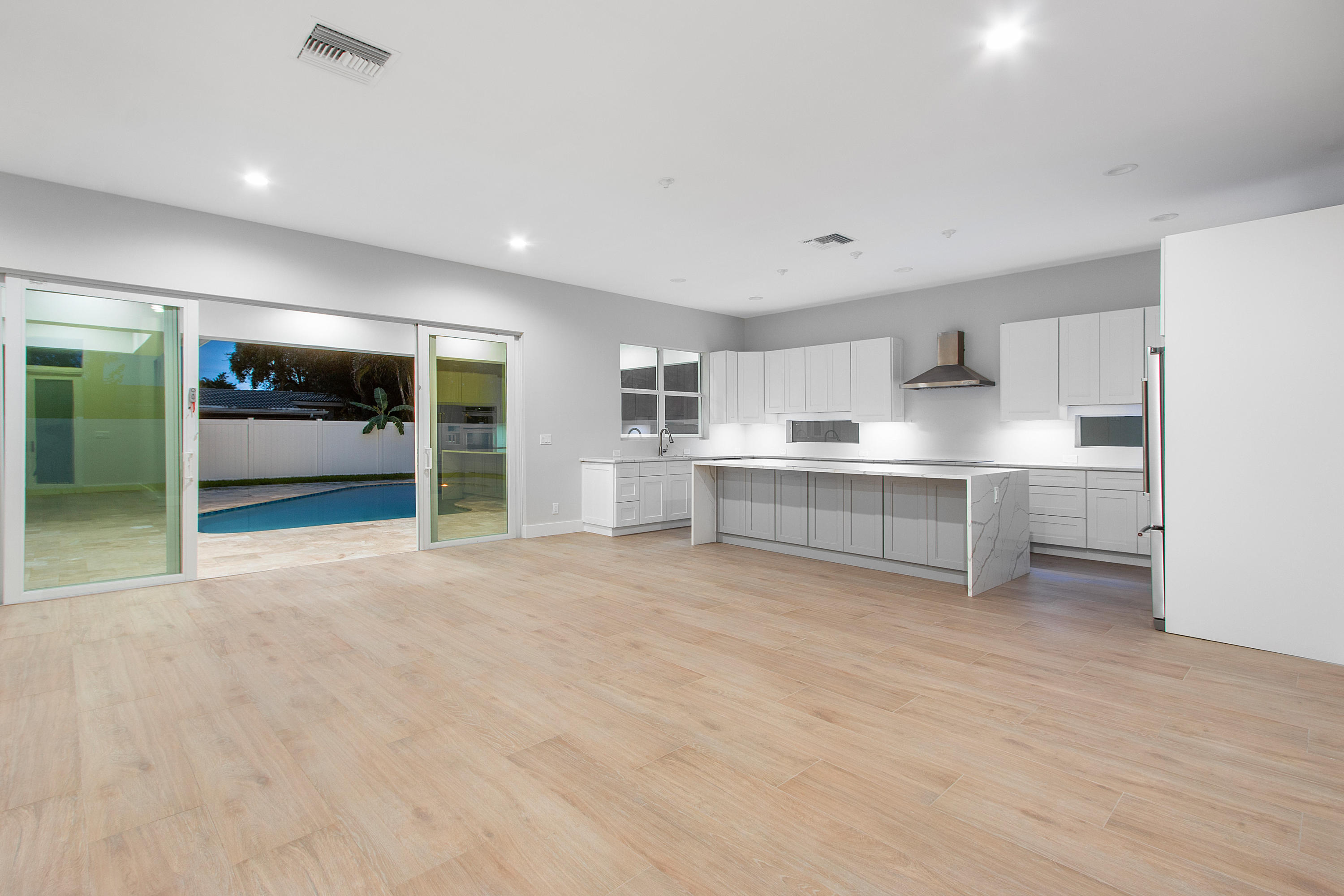 132 Southwest 7th Terrace Boca Raton, FL 33486 - Photo 11 of 39 a view of kitchen with wooden floor and windows