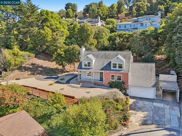 an aerial view of a house with a yard basket ball court and outdoor seating