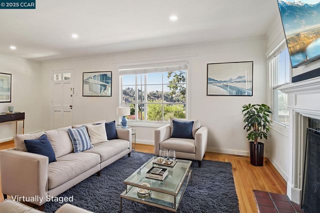 a view of a room with furniture and wooden floor