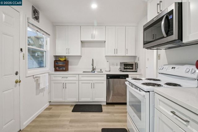 a bedroom with furniture and a wooden floor