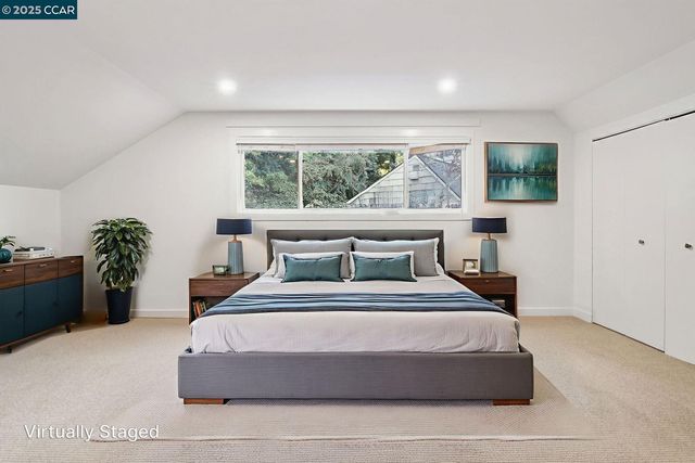 a view of a house with a yard and potted plants