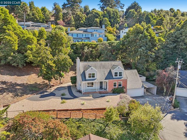 an aerial view of a house with a yard and garden