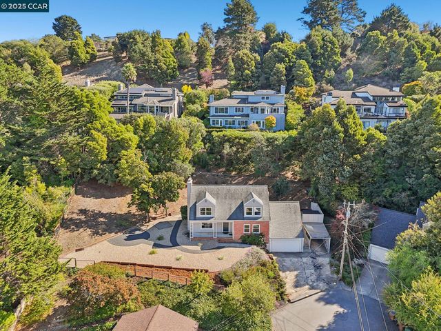 an aerial view of a house with a yard