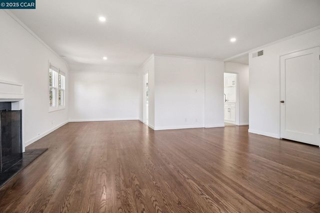 a view of wooden floor and windows in an empty room