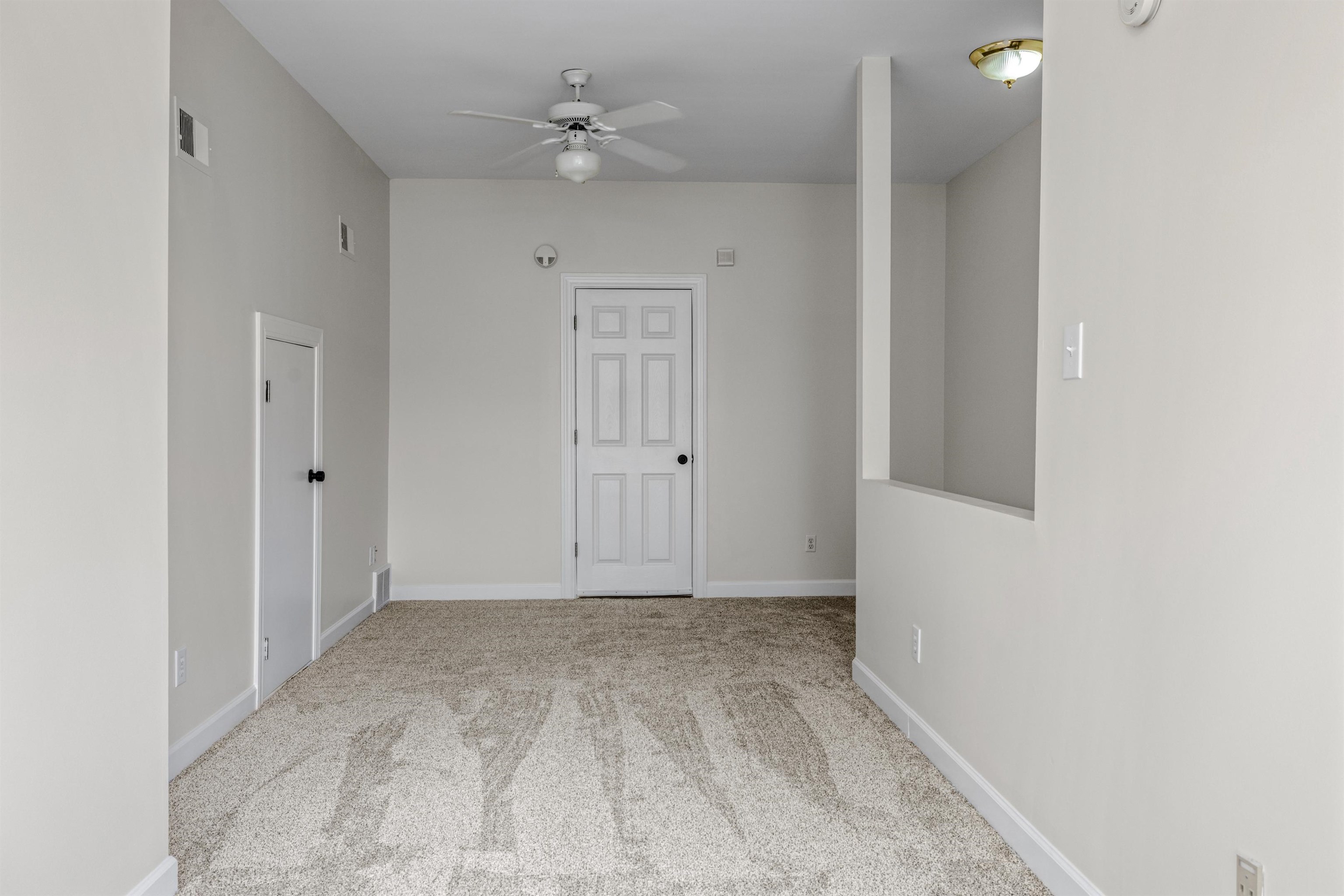 921 Harbor View Drive Memphis, TN 38103 - Photo 16 of 33 Carpeted interior space featuring light neutral wall tones and a ceiling-mounted fan with light fixture