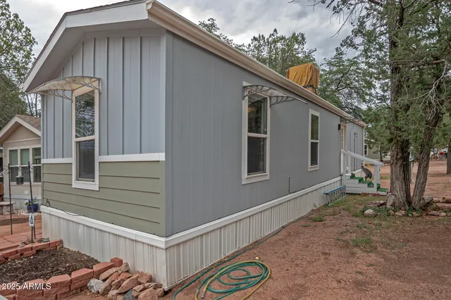 a view of a house with backyard and deck