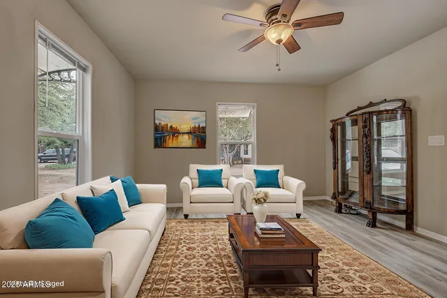 a living room with furniture and wooden floor