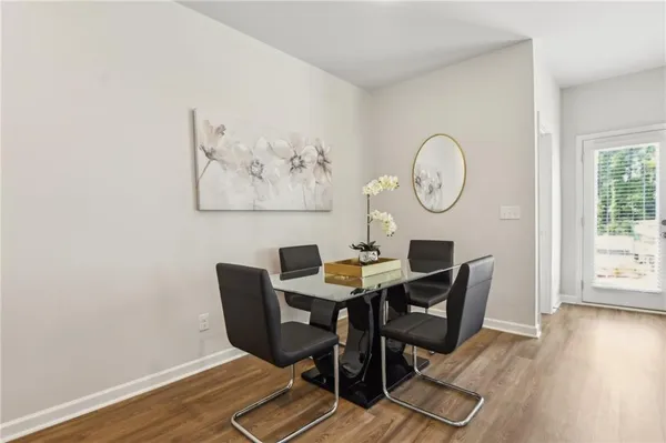 a view of a dining room with furniture and wooden floor