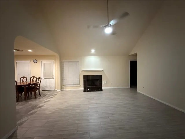 an empty room with furniture and a fireplace