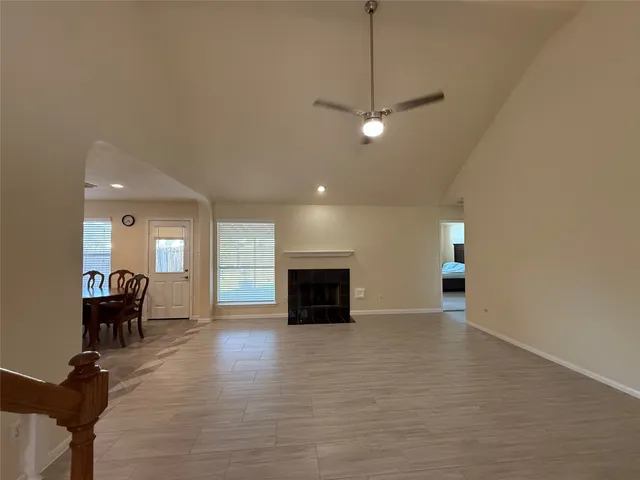 a view of a livingroom with furniture fireplace and wooden floor
