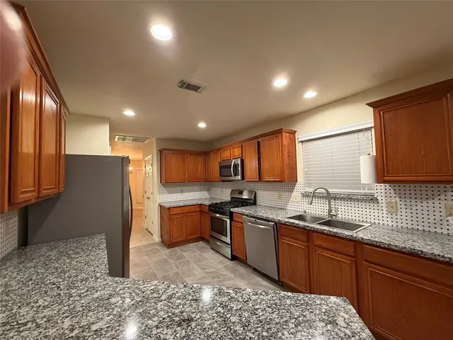 a kitchen with lots of counter top space and appliances
