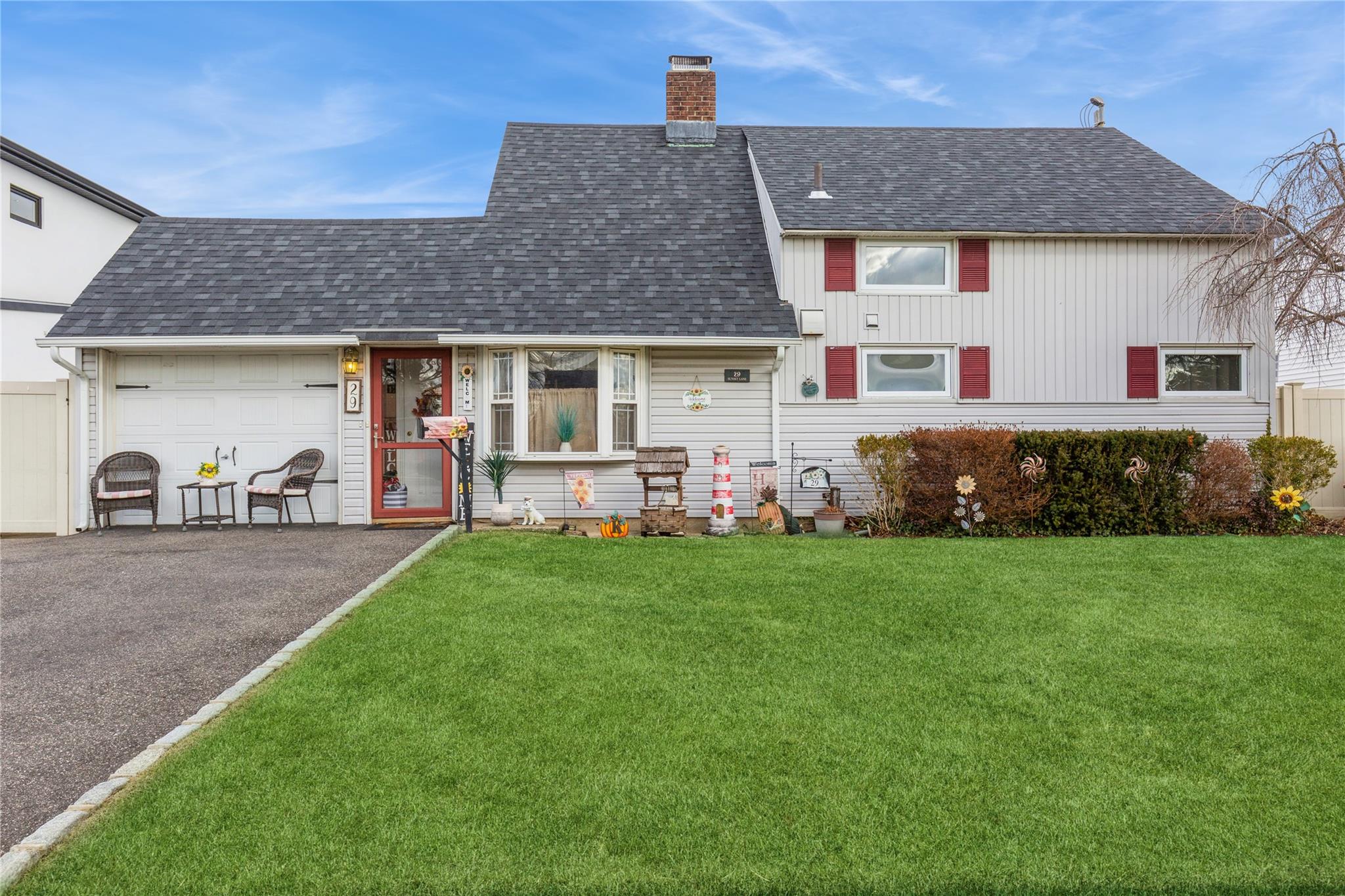 View of front of property featuring a front yard and a garage