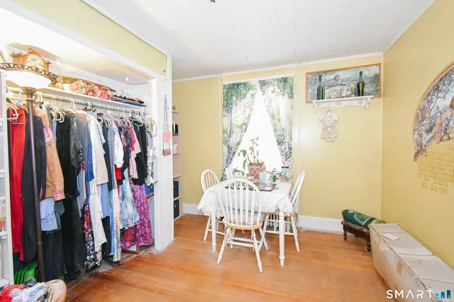 a view of a room with furniture and clothes