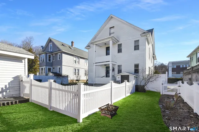 a view of an house with backyard and furniture