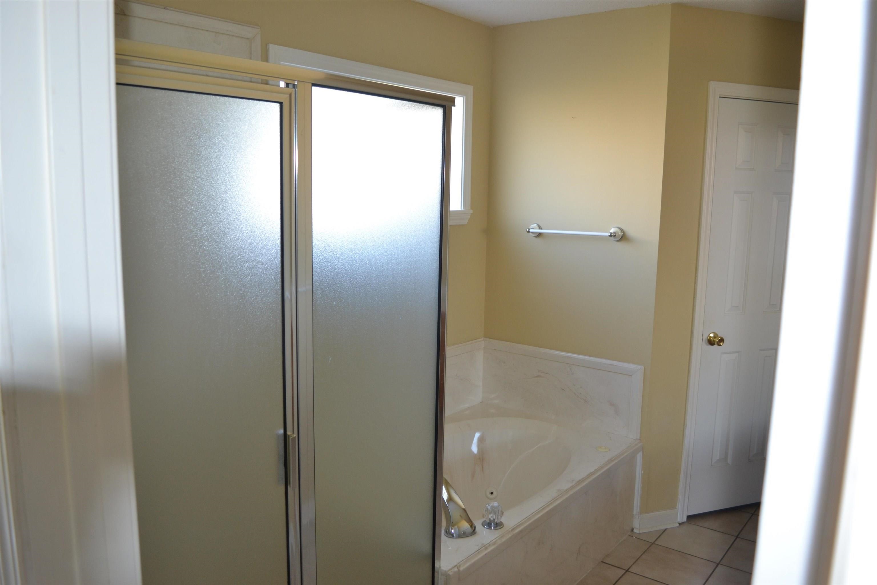 3078 Meade Lake Road Atoka, TN 38004 - Photo 6 of 8 Full bathroom with a stall shower, a bath, and light tile patterned floors