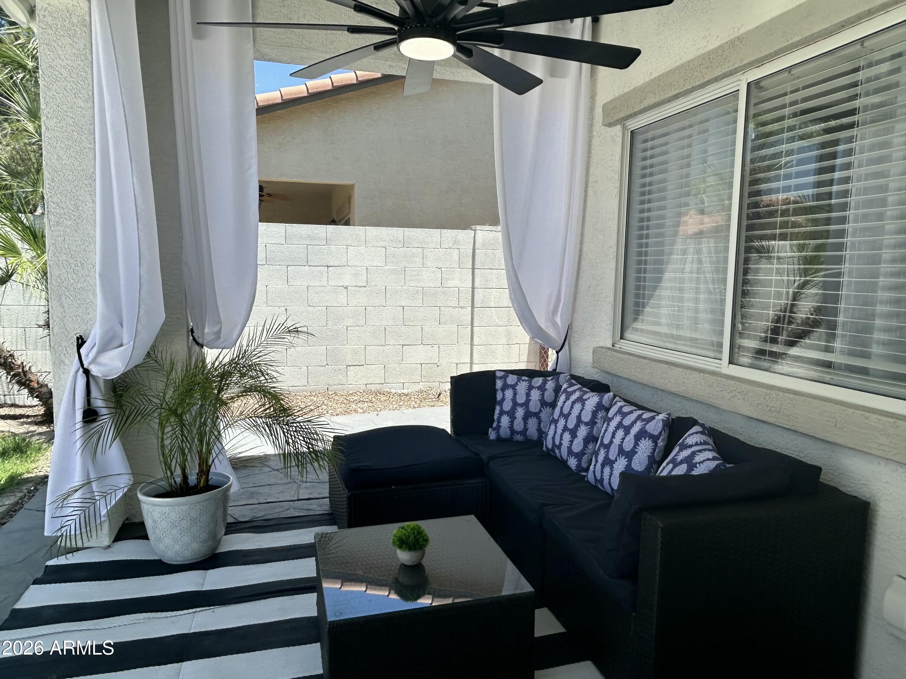 3674 South Joshua Tree Lane Gilbert, AZ 85297 - Photo 27 of 30 a living room with furniture and a potted plant