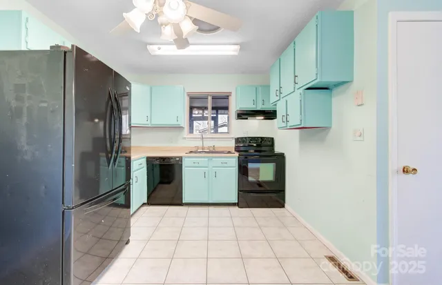 a kitchen with stainless steel appliances a refrigerator sink and cabinets