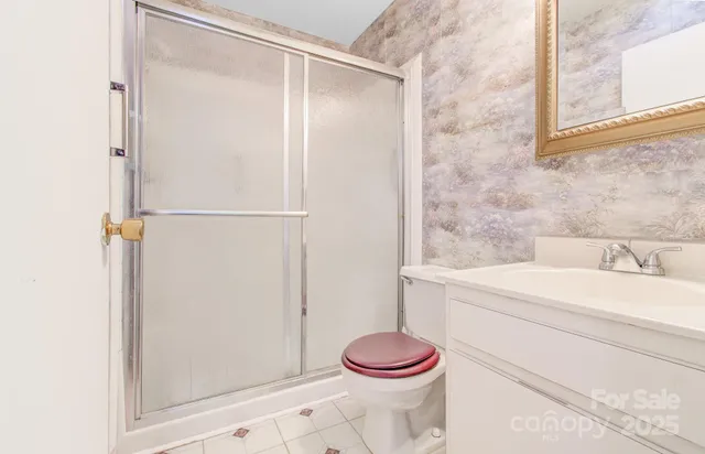 a spacious bedroom with a bed and a chandelier