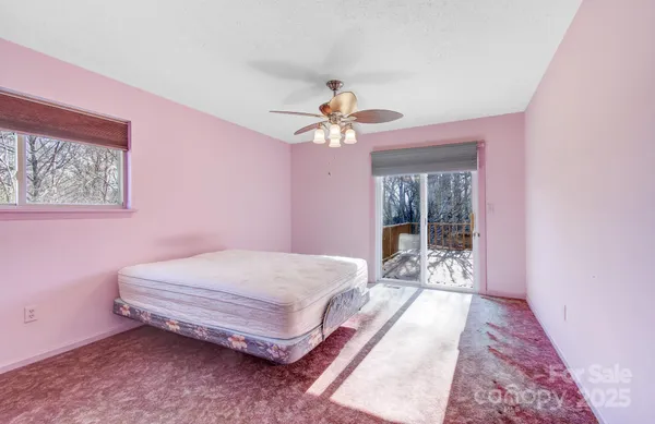 a view of a room with a ceiling fan and a window