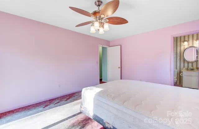 a bathroom with a toilet a sink and a mirror