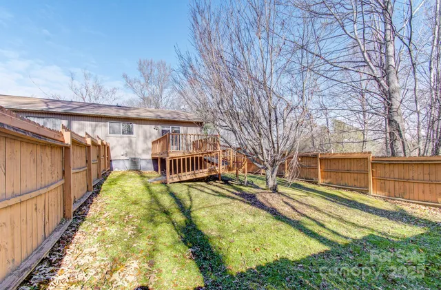 an empty room with closet and a chandelier fan