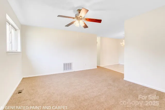 a view of a room with a ceiling fan and window