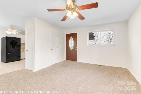 an empty room with windows and fan