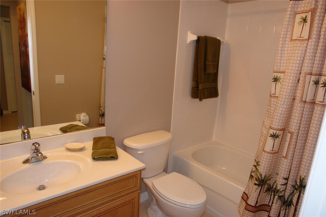 8251 Pathfinder Loop, Unit 624 Fort Myers, FL 33919 - Photo 11 of 15 a bathroom with a sink toilet and shower