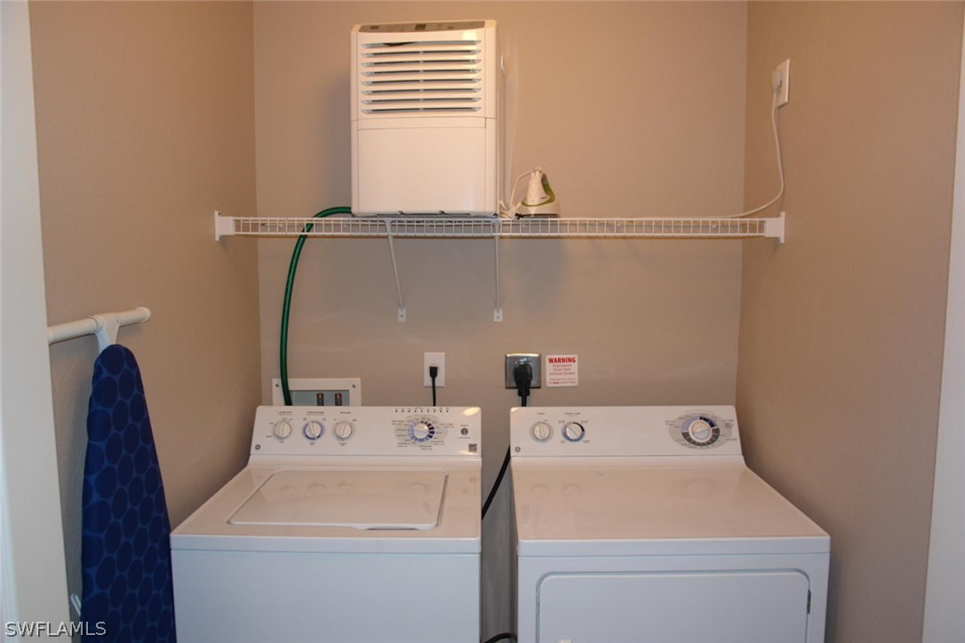 8251 Pathfinder Loop, Unit 624 Fort Myers, FL 33919 - Photo 12 of 15 a utility room with dryer and washer