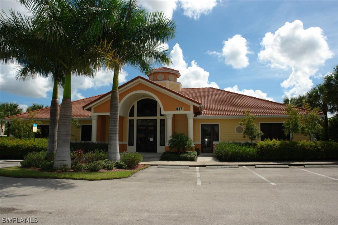 8251 Pathfinder Loop, Unit 624 Fort Myers, FL 33919 - Photo 14 of 15 a front view of a house with garden