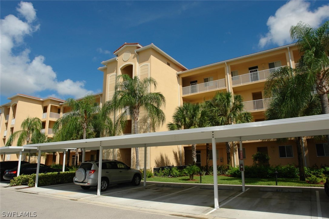 8251 Pathfinder Loop, Unit 624 Fort Myers, FL 33919 - Photo 2 of 15 a front view of a building with street view