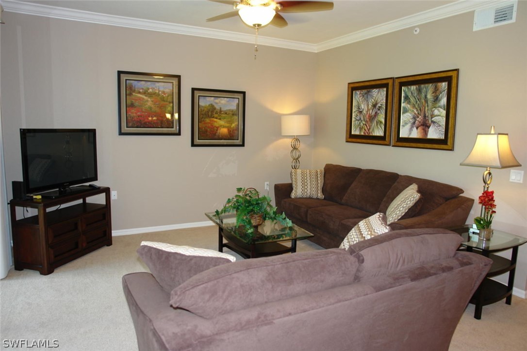 8251 Pathfinder Loop, Unit 624 Fort Myers, FL 33919 - Photo 3 of 15 a living room with furniture and a flat screen tv