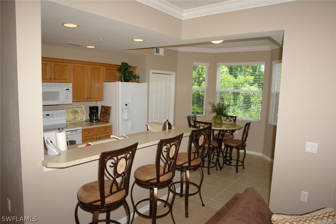 8251 Pathfinder Loop, Unit 624 Fort Myers, FL 33919 - Photo 5 of 15 a view of a dining room with furniture and a window